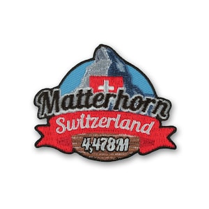 Pode incluir: Etiqueta bordada com uma imagem estilizada do Matterhorn, montanha da Suíça. A etiqueta é vermelha, azul, branca e cinza com o texto "Matterhorn Suíça 4,478M".