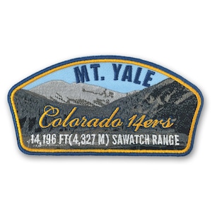 May include: Embroidered patch featuring a mountain landscape with the text "MT. YALE Colorado 14ers" in gold lettering. The patch includes the elevation of 14,196 ft (4,327 m) and "SAWATCH RANGE" at the bottom.