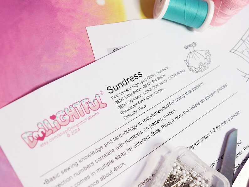 May include: A white paper pattern for a sundress for dolls. The pattern is titled "Sundress" and includes instructions for different doll sizes. The pattern is from the Etsy shop DollightfulPatterns.