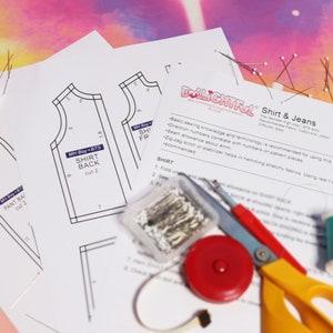 May include: A sewing pattern for a shirt and jeans with instructions and a list of materials. The pattern pieces are laid out on a white surface with sewing supplies, including thread, pins, scissors, and a measuring tape.