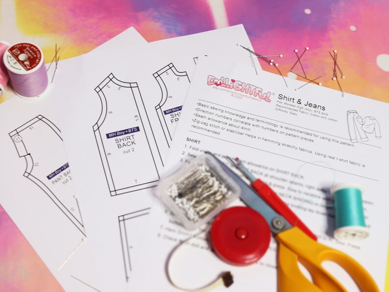 May include: A sewing pattern for a shirt and jeans with instructions and a list of materials. The pattern pieces are laid out on a white surface with sewing supplies, including thread, pins, scissors, and a measuring tape.