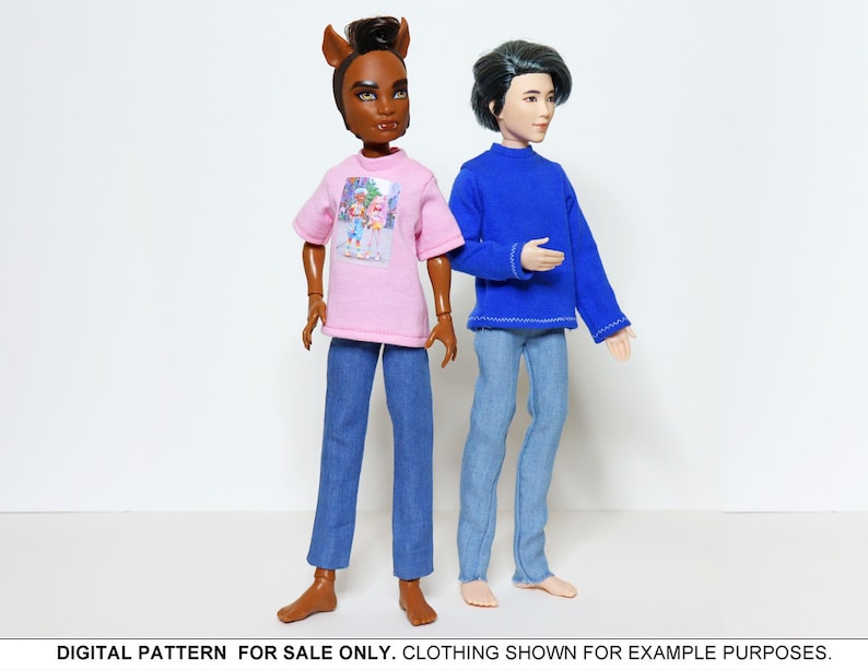 May include: Two dolls wearing casual clothing. One doll is wearing a pink t-shirt with a graphic print and blue jeans. The other doll is wearing a blue long-sleeved shirt and blue jeans.