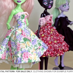 May include: Three dolls wearing floral print dresses. The doll on the left is green with pink hair and is wearing a white and green floral dress with a white lace trim. The doll in the middle is black with black hair and is wearing a red and white floral dress with a pink lace trim. The doll on the right is purple with green hair and is wearing a black dress.
