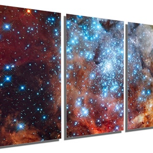 May include: A vibrant, multi-colored space nebula with a cluster of bright blue stars in the center. The nebula is a mix of red, orange, and blue hues, creating a stunning cosmic landscape.