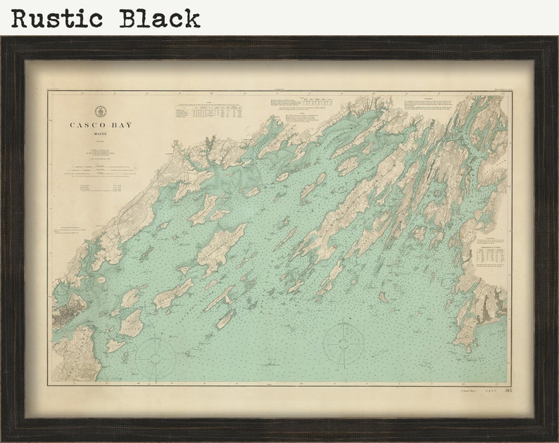 May include: A vintage map of Casco Bay, Maine, in a rustic black frame. The map is printed on cream-colored paper with a light blue and brown color scheme. The title "Casco Bay, Maine" is printed in the upper left corner.