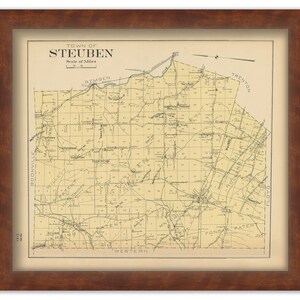 May include: Framed vintage map of the Town of Steuben, featuring detailed roads, place names, and a scale of miles. The map is printed on aged paper and encased in a dark brown wooden frame, creating a classic aesthetic.