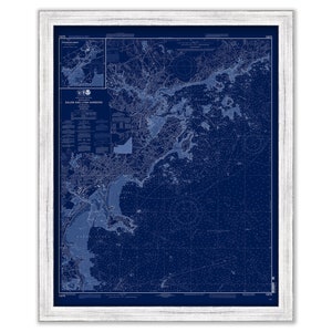 May include: A vintage nautical chart of Salem and Lynn Harbors, Massachusetts, printed in blue ink on a dark blue background. The chart shows the coastline, islands, and waterways of the area, with detailed markings for depths, buoys, and other navigational features.