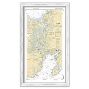 May include: A nautical chart of Block Island Harbor and the surrounding area, including the Annonymous River. The chart is printed on a cream-colored background with blue and brown lines and text. The chart is framed in a white frame.