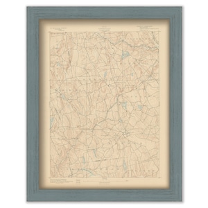 May include: A vintage map of the area around the town of Sharon, Massachusetts. The map shows the surrounding towns and features topographical details in brown and blue.