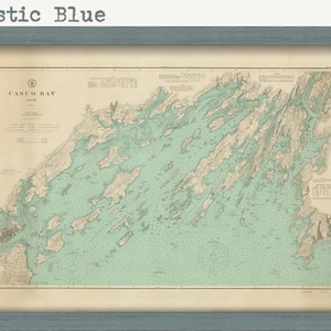 May include: A vintage map of Casco Bay, Maine, in a rustic blue frame. The map is printed on aged paper with a light blue and beige color scheme. The title "Casco Bay, Maine" is printed in the top left corner.