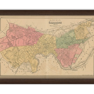 May include: An antique map of Cambridge, Massachusetts, showing the city's streets and neighborhoods in a vintage style. The map is printed in black, brown, green, pink, and yellow on a cream-colored background. The title "City of Cambridge, Mass." is printed at the top of the map.
