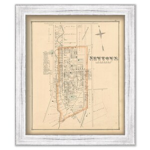 May include: An antique map of Newtown, Connecticut, printed on cream-colored paper with brown and orange ink. The map shows the layout of streets and buildings in the town. The title "NEWTOWN, CONN." is printed in the upper right corner.