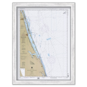 May include: A nautical chart of the waters off the coast of North Carolina, from Bethel Shoal to Cape Lookout. The chart is printed on paper and framed in a white frame. The chart shows the coastline, inlets, and waterways of the area. It also shows the location of buoys, lights, and other navigational aids.