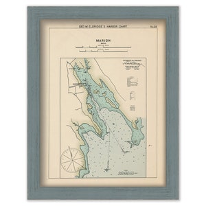 May include: A vintage nautical chart of Marion, Massachusetts, with a compass rose and detailed markings for depths and buoys. The chart is framed in a light blue wood frame.