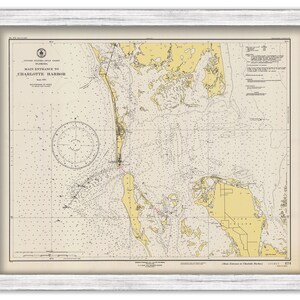 May include: A vintage nautical chart of the main entrance to Charlotte Harbor, Florida. The chart is printed on cream-colored paper with yellow and brown markings. The chart includes a compass rose and depth soundings.