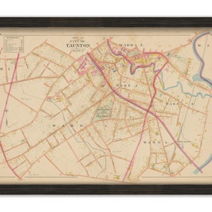 May include: A vintage map of Taunton, Massachusetts, showing the city's wards and streets. The map is printed in black, red, and blue ink on a cream-colored background.