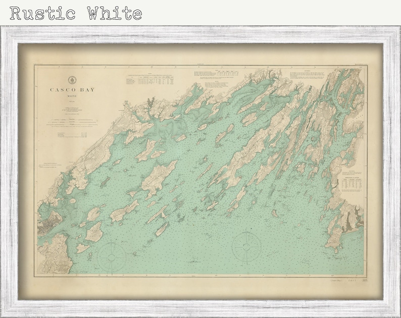 May include: A vintage map of Casco Bay, Maine, printed on aged paper with a rustic white frame. The map shows the coastline and islands of the bay in detail, with a light green color for the water and brown lines for the land.