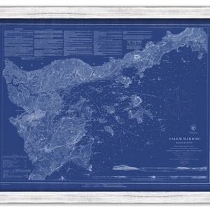 May include: A vintage nautical chart of Salem Harbor, Massachusetts. The chart is printed in white on a blue background and shows the coastline, islands, and depths of the harbor. The chart is framed in a white frame.