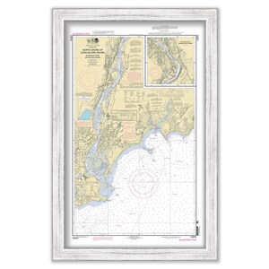 May include: A nautical chart of the North Shore of Long Island Sound, New York, with detailed markings for navigation. The chart is framed in a white wood frame.