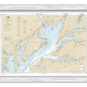 May include: A nautical chart of the Head of Chesapeake Bay, showing the waterways and islands in the area. The chart is printed in black, blue, and red on a white background. It includes compass roses, depth soundings, and other navigational information.