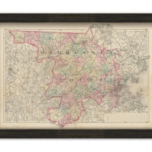 May include: An antique map of Middlesex County, Massachusetts, showing the towns and roads. The map is printed in black and white with colored borders for each town. The map is framed in a dark wood frame.