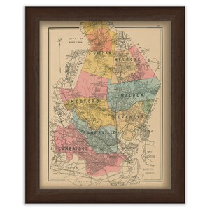 May include: A vintage map of the Boston, Massachusetts area, showing the surrounding towns and cities. The map is in a brown frame and is printed on a cream-colored paper. The map is color-coded to show the different towns and cities. The map is titled "Boston" and is dated 1897.