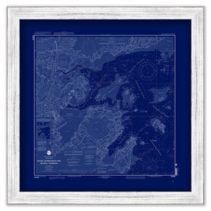 May include: A vintage nautical chart of Salem, Marblehead and Beverly Harbors, Massachusetts. The chart is printed in white on a dark blue background and framed in white.