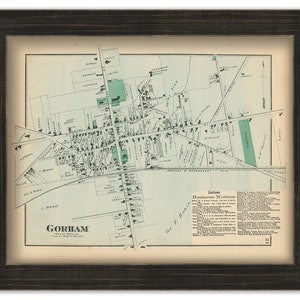 May include: An antique map of Gorham, Maine, printed in black and white with green accents. The map shows the town's streets, buildings, and businesses. The map is framed in a dark wood frame.