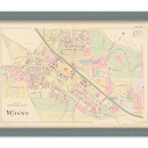 May include: A vintage map of Wayne, Pennsylvania, showing streets, parks, and buildings. The map is printed on paper and has a light brown background with pink and green accents. The title "Wayne" is printed in large, bold letters at the bottom of the map. The map is labeled "Plate 2" in the upper right corner.