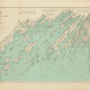 May include: A vintage map of Casco Bay, Maine, with detailed coastline and islands. The map is printed in shades of blue, green, and brown, with a compass rose in the lower left corner. The title "Casco Bay, Maine" is printed in the upper left corner.