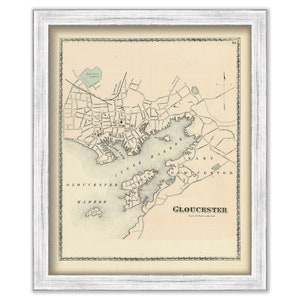 May include: An antique map of Gloucester, Massachusetts, showing the harbor and surrounding area. The map is printed in black and white on a cream-colored paper. The title "GLOUCESTER" is printed in the lower center of the map.
