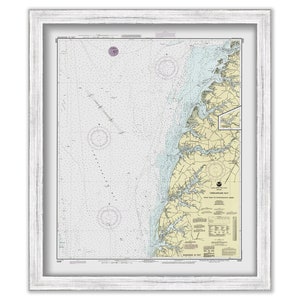 May include: A framed nautical chart of Chesapeake Bay, Virginia, with detailed markings and a compass rose. The chart is printed on white paper with blue and yellow markings. The frame is white with a distressed finish.