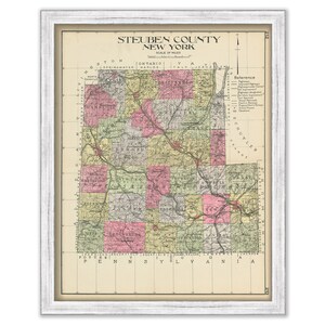 May include: A vintage map of Steuben County, New York, with a scale of miles. The map is divided into townships and shows roads, railroads, and other features. The map is in a white frame.