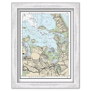 May include: A nautical chart of Hull Bay, Massachusetts, showing the coastline, islands, and waterways. The chart is printed in black and white with blue and green accents. The chart is framed in a white frame.