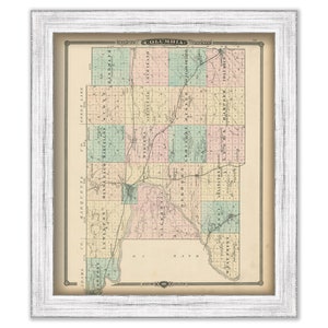 May include: An antique map of Columbia County, Wisconsin, showing the townships and roads. The map is printed in black and white with colored borders for each township. The map is framed in a white frame.