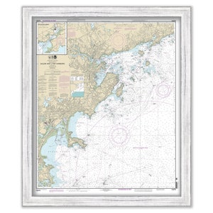 May include: A nautical chart of Salem and Lynn Harbors, Massachusetts. The chart shows the coastline, islands, and waterways of the area. It includes details such as depths, buoys, and other navigational aids. The chart is printed on paper and framed in a white wood frame.