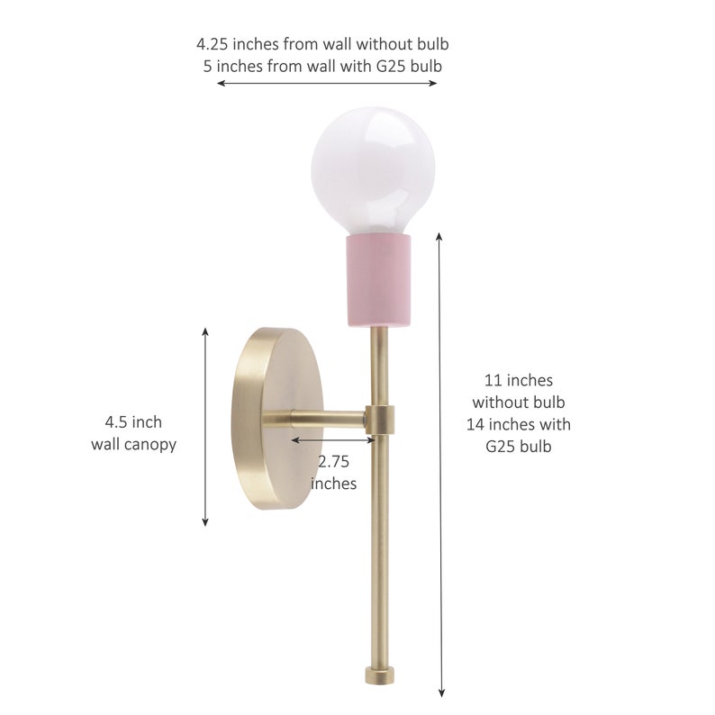 May include: A modern wall sconce with a brass finish, featuring a pink bulb holder and a white G25 bulb. The sconce is 11 inches (28 cm) tall without the bulb and 14 inches (36 cm) with the bulb. The wall canopy is 4.5 inches (11 cm) in diameter.