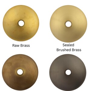 May include: Four brass finish options for a product: Raw Brass, Sealed Brushed Brass, Aged Brass, and Blackened Brass. Each finish is shown as a round disc with a small hole in the center.