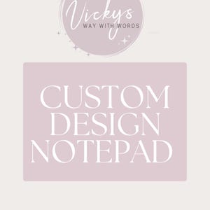 May include: A pale pink notepad featuring the text "CUSTOM DESIGN NOTEPAD" in white. Above, a circular logo reads "Vicky's Way With Words" in cursive script, set against a pale pink background.