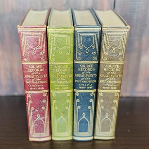 May include: Four antique books titled "Source Records of the Great Events of the Post War Period" in various colors. The spines are red, green, navy, and tan, with gold lettering and decorative elements. The books cover the years 1919-1931.