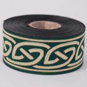 May include: A roll of green and gold trim with a Celtic knot design. The trim is approximately 1 inch wide.