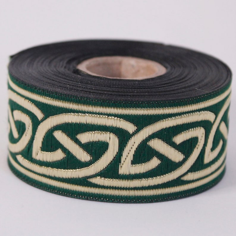 May include: A roll of green and gold trim with a Celtic knot design. The trim is approximately 1 inch wide.