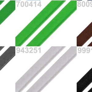 May include: A close-up of ten different colors of double-fold bias tape. The colors are turquoise, green, brown, gray, white, black, beige, and more. The tape is 1/2 inch wide.