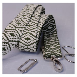 May include: A green and white patterned fabric strap with silver hardware, including a swivel clasp and a slider buckle.