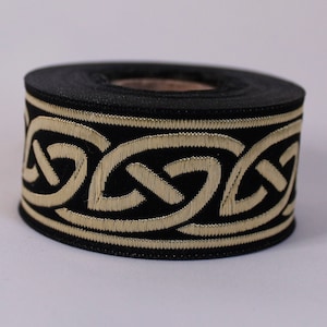 May include: Black ribbon trim with a gold Celtic knot design.