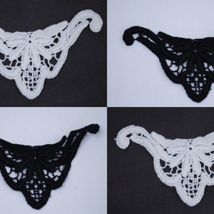 May include: Four lace appliques, two black and two white, in a delicate floral design. Each applique is shaped like a curved, pointed triangle.