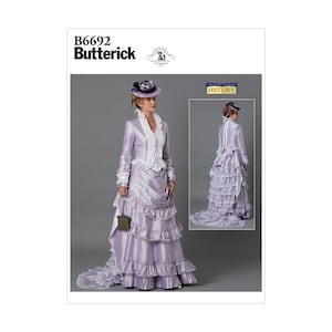 May include: A vintage sewing pattern for a woman's dress with a long train. The pattern is from Butterick and is number B6692. The dress is a light purple colour with white lace trim. The model is wearing a matching hat.