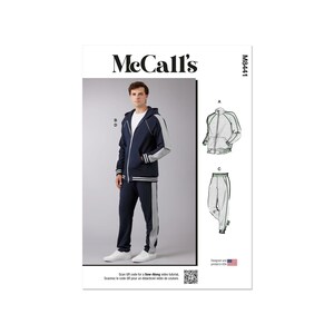 May include: A sewing pattern for a men's tracksuit with a navy blue hooded jacket and matching grey sweatpants. The pattern includes a zippered jacket with a white trim and a contrasting grey panel on the sleeves. The sweatpants have a grey stripe down the side of each leg. The pattern is from McCall's and the pattern number is M8441.