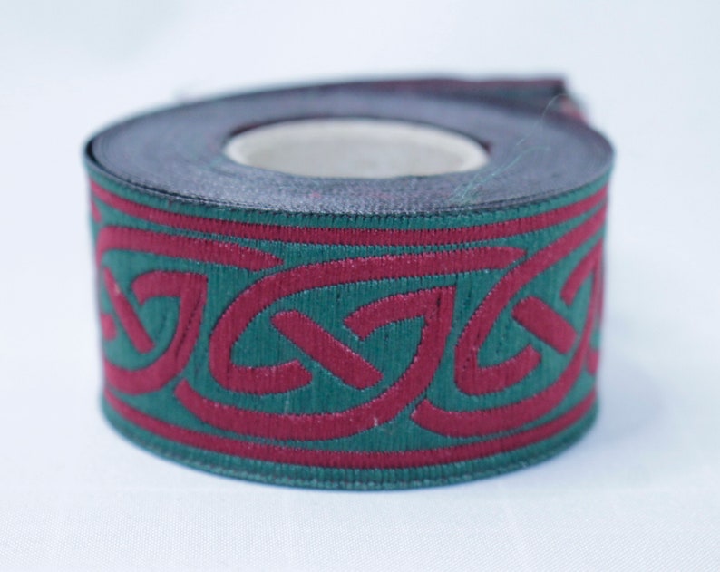 May include: A roll of green and burgundy trim with a Celtic knot design.