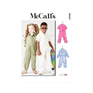 May include: McCall's M6567 sewing pattern for children's dungarees. The pattern includes three different styles: a pink dungaree, a white dungaree, and a blue dungaree. The pattern is designed and printed in the USA.